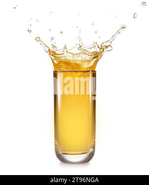 Crown-shaped splash of apple juice overflowing out of a tall glass isolated on white background. Stock Photo