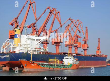 YANTAI, CHINA - NOVEMBER 21, 2023 - Cargo ships load and unload cargo at Longkou port area of Yantai Port, east China's Shandong Province, Nov 21, 202 Stock Photo