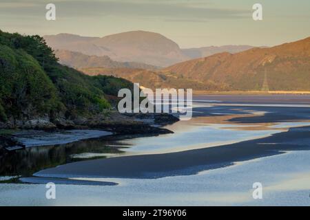 The River Dwyryd in Portmeirion, Wales. The river is in the foreground and winds through the image. The background consists of mountains and hills in Stock Photo