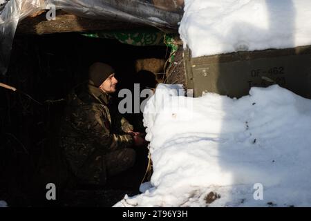Kupyansk, Kharkiv Oblast, Ukraine. 22nd Nov, 2023. Andriy, a Ukrainian service member sits inside a trench near an artillery positions. Commanding an artillery position in the region, Ukrainian troops prepare for winter and potential Russian assaults. (Credit Image: © Madeleine Kelly/ZUMA Press Wire) EDITORIAL USAGE ONLY! Not for Commercial USAGE! Stock Photo