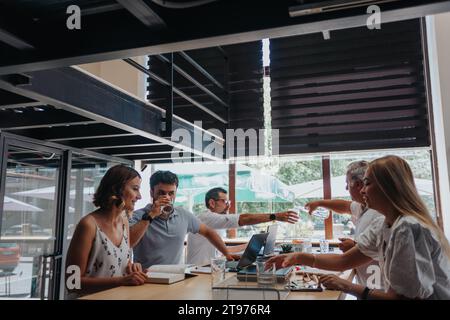 Cross Generational Efficient Team of Multiracial Business Partners Analyzing Reports for Future Success Stock Photo