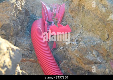 Cables in the trench. High-voltage cables in a protective covering in an excavation. Concept of electrical installations, construction works, building Stock Photo