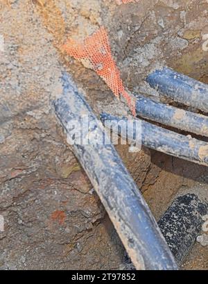 Cables in the trench. Cables in the excavation ready for electrical installation. Concept of electrical installations, construction work, building ren Stock Photo