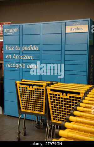 Madrid, Spain, Nov 18, 2023, Amazon Locker the self-service parcel delivery service station in supermarket to retrieve cardboard box Stock Photo