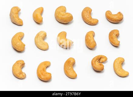 Cashew nuts laid out in rows on white background. Stock Photo