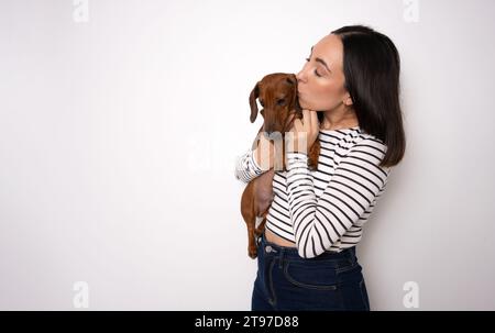Photo of cute millennial lady hug dog wear striped shirt isolated on white color background Stock Photo