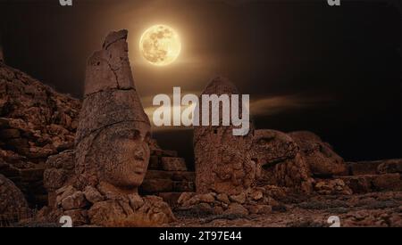 Antique ruined statues at sunrise on Nemrut mountain in Turkey. ancient Kingdom of Commagene in south east Turkey. Stock Photo