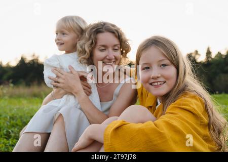 Smiling mother and daughters spending leisure time with each other Stock Photo