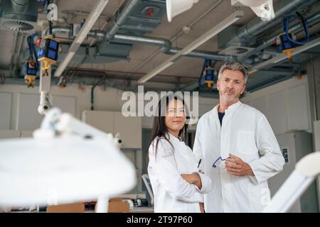 Smiling scientists standing together in laboratory Stock Photo