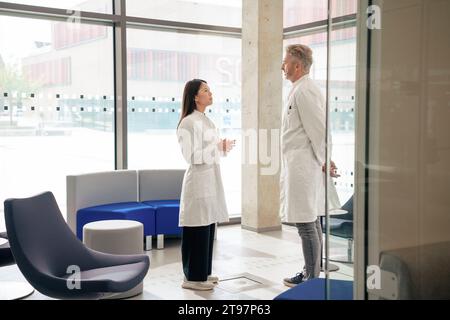 Doctors having discussion in laboratory lobby Stock Photo