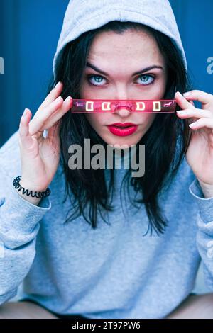 Young woman with blue eyes adjusting smart glasses Stock Photo