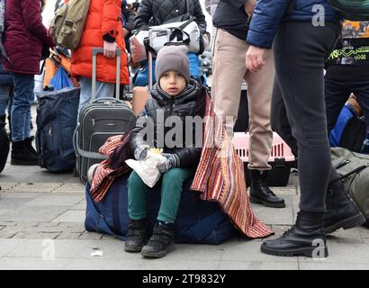 Lviv, Ukraine - March 6, 2022: Refugees near railway station of Lviv waiting for the train to Poland. Stock Photo