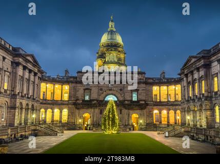 Edinburgh, UK. 23rd Nov, 2023. Weather, Christmas A view of the illuminate Christmas Tree as a centre point in the historic Old College quadrant of the University of Edinburgh, South Bridge, Edinburgh, Scotland. The statue ‘Golden Boy' sits on top of the impressive dome on top of the Old College building. Edinburgh University is continuously ranked as one of the top universities in the UK. Picture Credit: phil wilkinson/Alamy Live News Stock Photo