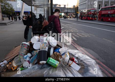 Coffee and soft drinks cups from some of the major take away food and drinks companies piled up on top of an overflowing street rubbish bin on 15th November 2023 in London, United Kingdom. At certain times, especially weekends and public holidays, the volume of people in the area generates a big problem with trash. Rubbish piles high in certain places and proves unsightly for such an important area of London. Stock Photo