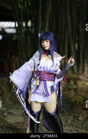 Portrait of a beautiful young woman game cosplay with samurai dress costume on Japanese garden Stock Photo