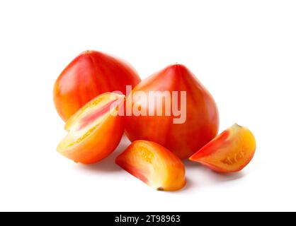 Whole and cut large organic striped yellow-red tomatoes isolated on white background, close-up Stock Photo