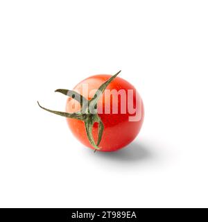 One fresh organic cherry tomato with green tail isolated on white background closeup. Products for a healthy diet. Stock Photo
