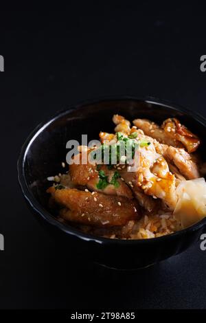 Grilled Chicken teriyaki rice Japanese food isolated in black background Stock Photo