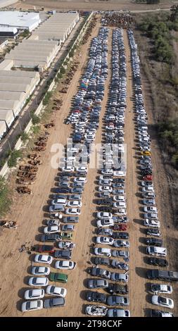 Hundreds of Israeli vehicles stacked in a lot outside Netivot, southern Israel, near the border with the Gaza Strip as seen in an aerial photograph on November 23, 2023. These vehicles and hundreds of others were destroyed during the October 7, 2023 Hamas terrorist infiltrations and murders in which 1,200 Israelis were killed and some 240 people taken hostage back into Gaza. On November 24 Israel and Hamas are due to begin a ceasefire and exchange 50 Israeli hostages for 150 Palestinians prisoners held in Israel. The ceasefire is due to last five days with about 12 hostages being released each Stock Photo
