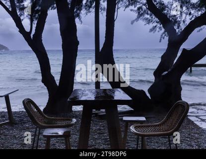 Winter landscape in a seaside town. Empty chairs and tables on a rainy day. A depressing sight. Stock Photo