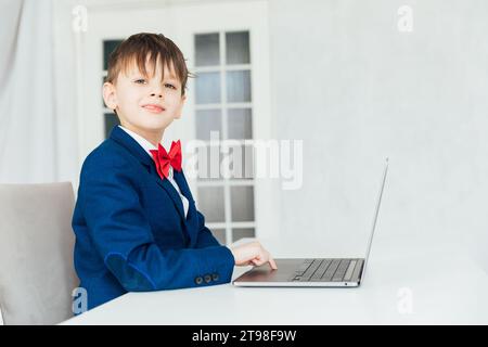 Business boy in jacket sitting at laptop Stock Photo