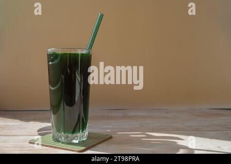 Organic blue-green algae spirulina detox drink in glass powder food. Health protein cocktail smoothie of chlorella. Vitamins and minerals to diet. Prebiotic and antioxidant rich Dietary supplement Seaweed superfood concept Stock Photo