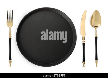 Empty black plate with fork, knife and spoon on white background, top view Stock Photo