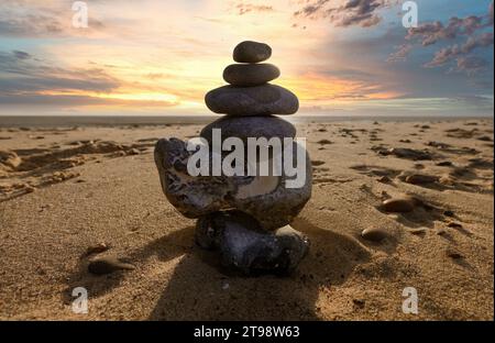 Zen stones on a beach with the sunrise Stock Photo