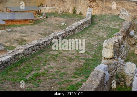 Part of an ancient road next to a defensive wall in the Athens Town Hall square Stock Photo
