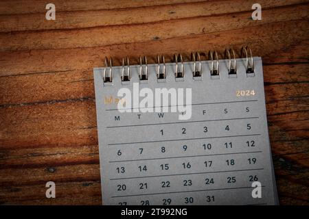 MAY 2024. Green cardboard calendar on a wooden texture background. Stock Photo