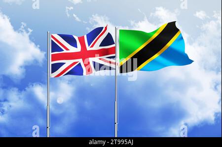 Tanzania,UK flags together waving against blue sky Stock Photo