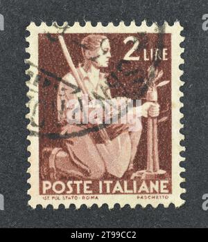 Cancelled postage stamp printed by Italy, that shows Farmer Grafting a Sapling, circa 1949. Stock Photo