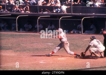 LOS ANGELES, CA - JULY 9:  Gordy Coleman #18 of the Cincinnati Reds swings at the pitch as catcher John Roseboro #8 of the Los Angeles Dodgers and umpire Dusty Boggess look on during an MLB game on July 9, 1961 at the Los Angeles Memorial Coliseum in Los Angeles, California.  (Photo by Hy Peskin) *** Local Caption *** Gordy Coleman;John Roseboro;Dusty Boggess Stock Photo