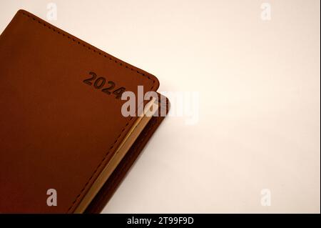 brown pocket planner for 2024 isolated on White, Denmark, November 22, 2023 Stock Photo