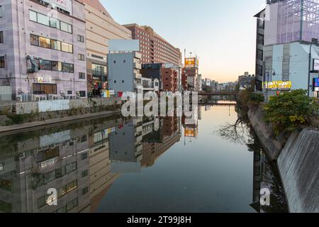 Fukuoka, JAPAN - Dec 6 2021 : A view of Nakasu in the evening. Naka River (Naka-gawa) and buildings can be seen in the image. Stock Photo