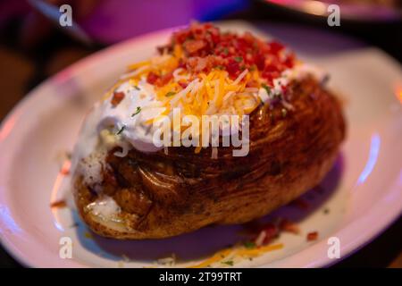 Fully loaded baked potato as a side Stock Photo