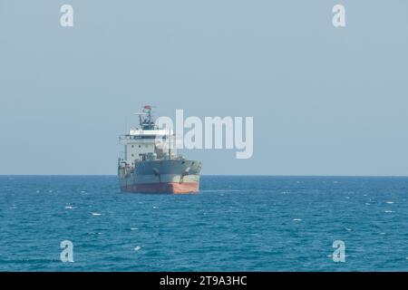 Front side view of oil tanker ship sailing on open sea. Stock Photo