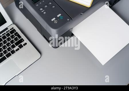 New modern printer and laptop in the office on table Stock Photo