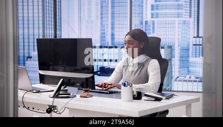 African Woman Using Computer for Business Communication with Banner Stock Photo