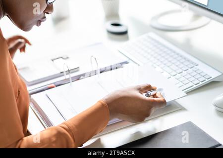 African-American Woman Conducting a Business Audit on Invoice Account Stock Photo