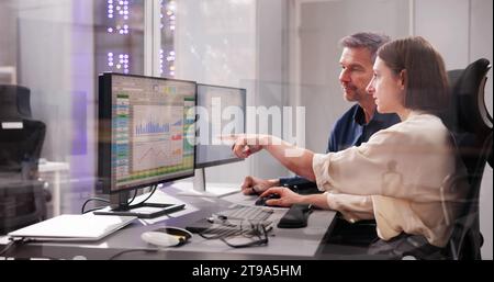 Working Analyst on Desktop Computer with Spreadsheets Stock Photo