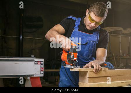 A carpenter using a jigsaw to cut wood cuts bars. Stock Photo