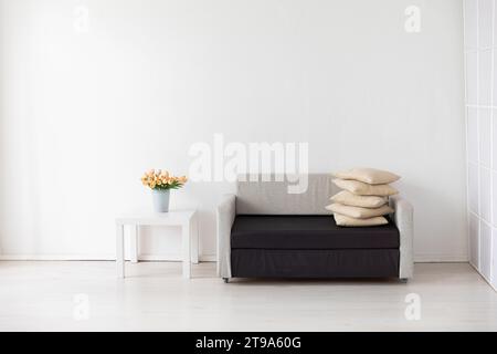 sofa with cushions coffee table with flowers on a white background Stock Photo
