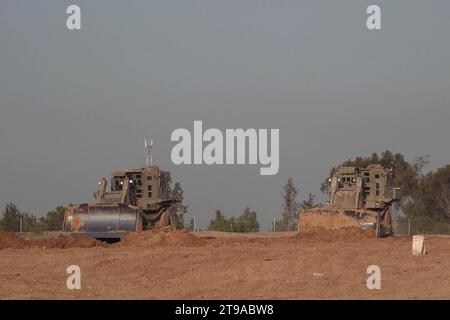 Israeli D9 armored military bulldozers work near the border with Gaza strip amid ongoing battles between Israel and Hamas on November 23, 2023 in Southern Israel. Stock Photo