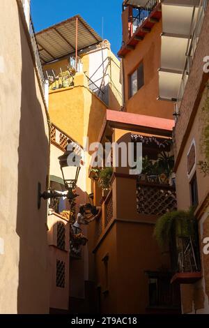 Romance of Guanajuato charming alleys with a photograph of lovers kissing against colorful architecture Stock Photo
