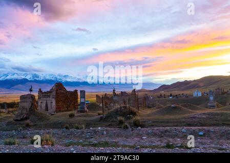 Traditional Muslim cemetery at the outskirts of a village in Kyrgyzstan Stock Photo