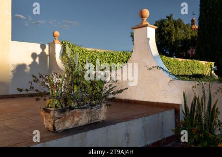 A Colonial house with old flowerpots in the patio Stock Photo