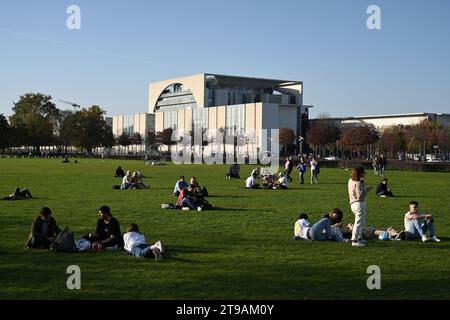 Berlin, Germany - October 31, 2022: People relax on the gras near the Federal Chancellery (Bundeskanzleramt) in Berlin. Stock Photo