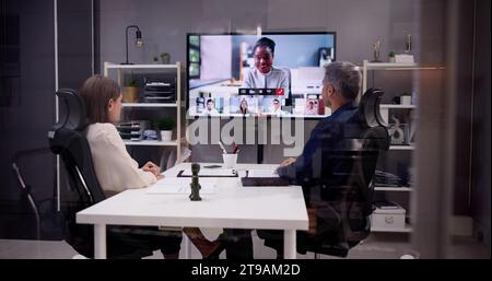 Business Conference with Videoconferencing: People on Computers Stock Photo