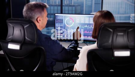Financial Performance Analytics on Computer Dashboard with People Stock Photo